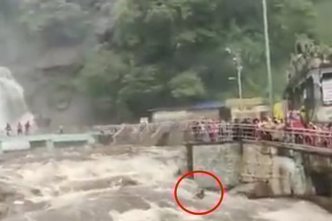 A person being washed away in Courtallam