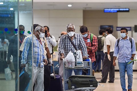 People at an airport coming out with masks