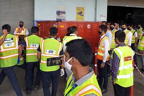 Personnel unloading Covishield vaccine boxes