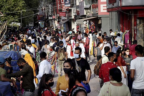 People, flouting COVID 19 appropriate behavior, visit a crowded Sarojini Market area during the ongoing coronavirus pandemic, in New Delhi
