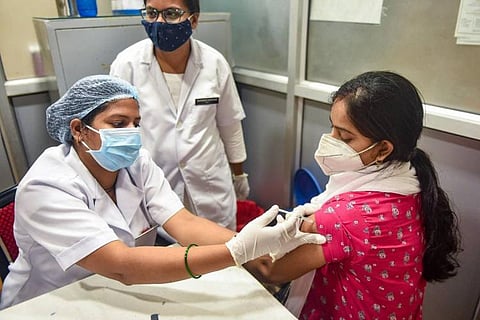 A woman being administered COVID-19 vaccine