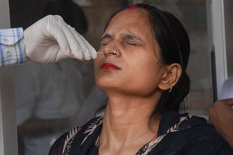 A woman getting swabbed for COVID-19 test