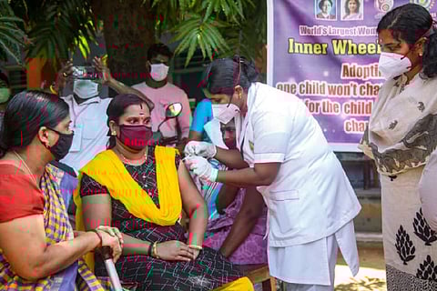 Health worker vaccinating a woman