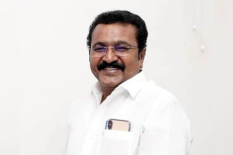 DMK MP TRVS Ramesh wearing a white shirt and smiling for picture