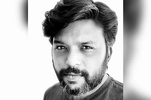 A black and white picture of Pultizer Prize-winning photojournalist Danish Siddiqui
