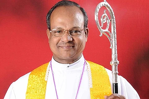 Dharmaraj Rasalam dressed in white vestment and holding crozier