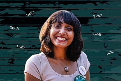 Bengaluru climate activist Disha Ravi in a white t-shirt smiling at the camera