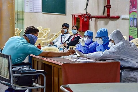 Healthcare personnel assessing a patient
