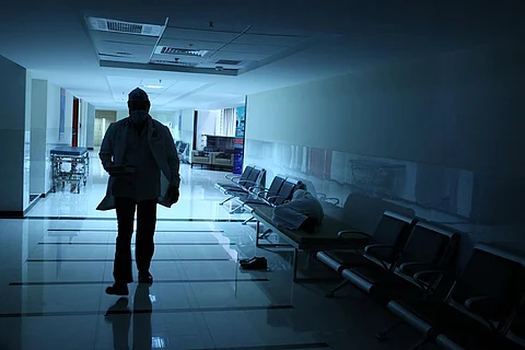 Doctor walking along a desolate corridor