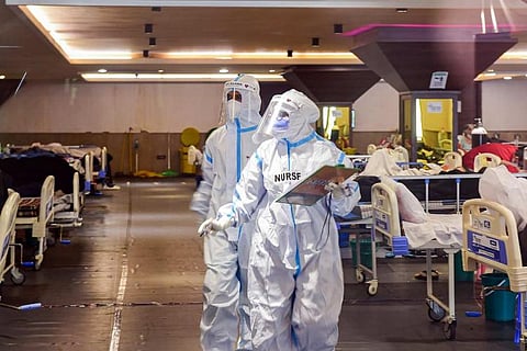 Doctors working wearing PPE kits on the hospital floor