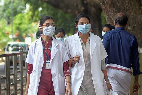 Two doctors walking on the road