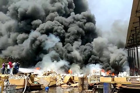 Firefighters trying to douse the flames after a fire at a scrapyard in Duvvada SEZ near Vizag