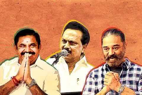 Three men against an orange background, man in the middle wearing a white shirt and holding a mike, on either side of him two men smiling with hands folded together.