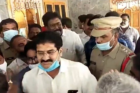 Ramakrishna Reddy being escorted by police from his residence