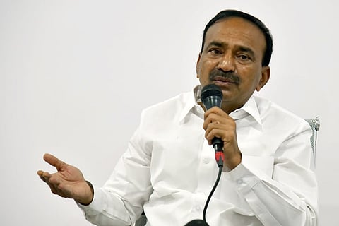 An image of Eatala Rajender with his hand stretched while addressing a gathering