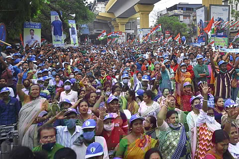 A large group of supporters holding flags and banners during a political rally
