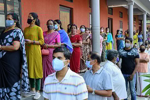 voters in booth wearing mask