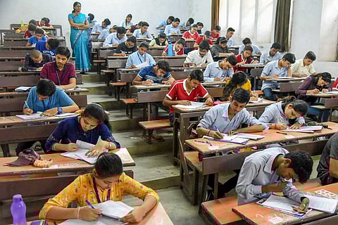 Students writing an exam in a classroom