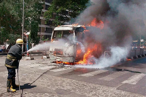 A fireman dousing a vehicle caught on fire