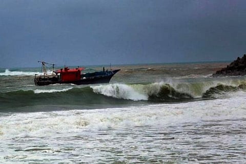 Representative image of fishermen sitting in a boat at sea