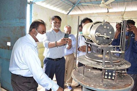 Officials looking at the musical flood warning system at Gandipet reservoir