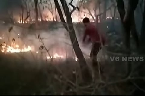 A man trying to douse the fire