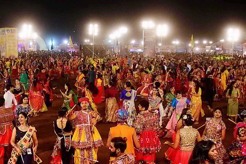 Representative image of people dancing at a garba and dandiya event held during Navratri