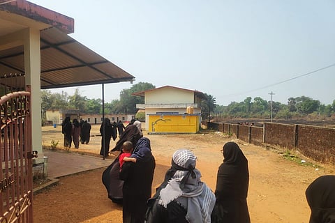 Girl students wearing burqa and hijab going into Government Composite Urdu High School in Karnataka