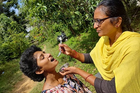 Class 10 student Greeshma's mother feeding her after the former scored the highest in the SSLC supplementary exam
