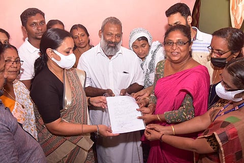 Kerala couple handing over land deed to Minister Veena George