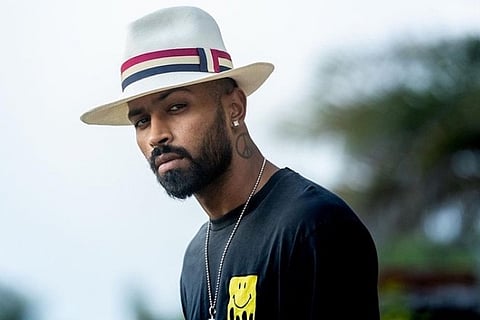 Hardik Pandya dressed in black T-shirt and wearing cap