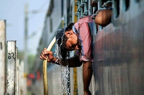 A man cooling himself in a train