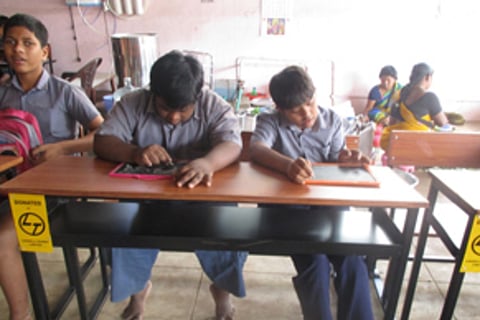 Children seated at their desks in Hidden Sprouts school in Vizag