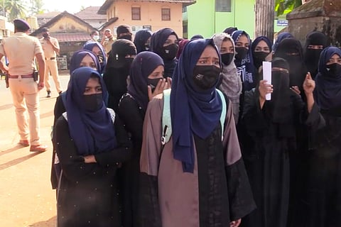 Muslim students dressed in a hijab protest outside their school