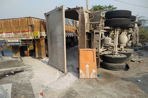 Truck overturned after collision at Himayat Sagar toll gate.
