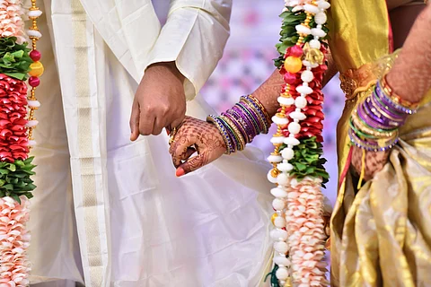 A bride and groom holding hands