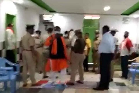 Hindutva activists standing with police at the resting room