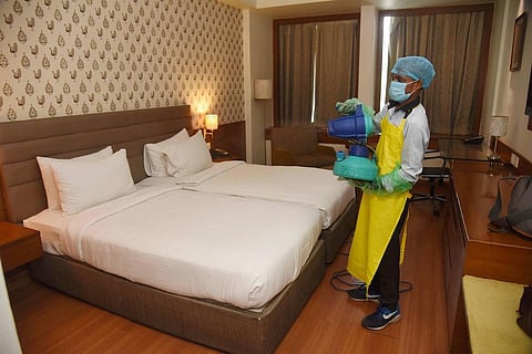 A worker sanitises a room in a hotel ahead of its reopening during the ongoing COVID-19 lockdown