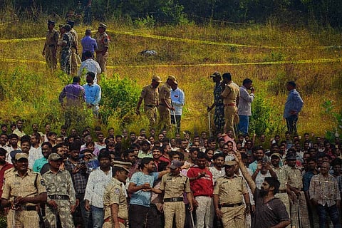 Scene of the Hyderabad encounter: Police and public standing in the field