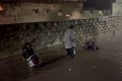 Two wheelers being washed away due to heavy rains and flooding in Hyderabad's Mallepally area