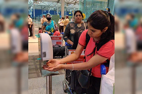 A passengers sanitizing her hands in the Hyderabad airport