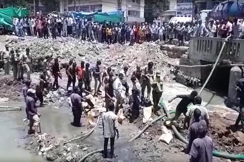 Police carrying the body of Sai from the drainage