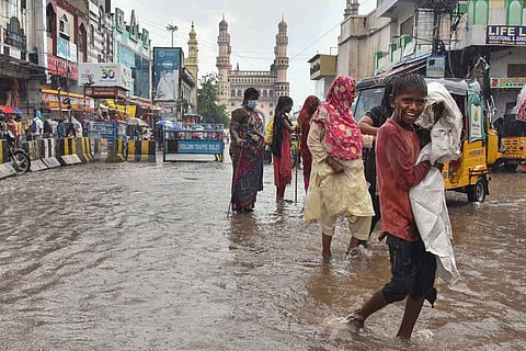 Commuters at the water-logged Charminar