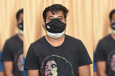 Vijay in a black shirt produced before the media