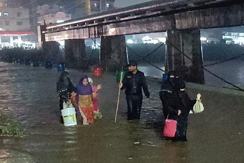 People crossing a waterlogged road