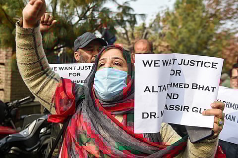 Hyderpora protester holding up banner