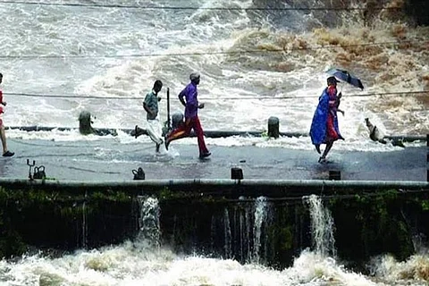 Watch: Dramatic video of rescue officer running with child through flooding Kerala bridge