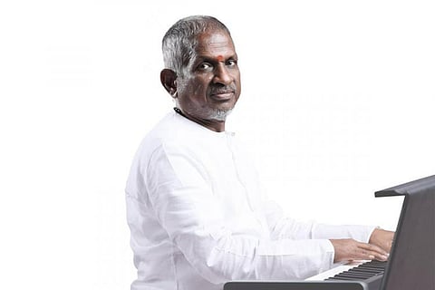 Ilaiyaraaja in white with a white background