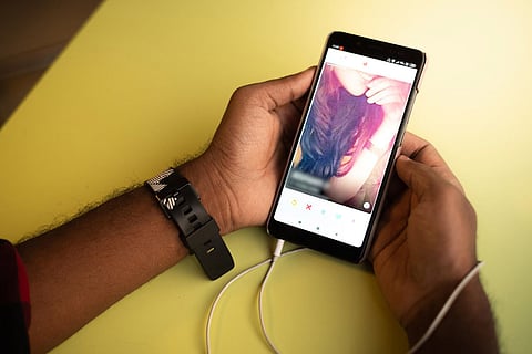 A person using a dating app on his phone