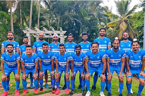 The Indian men's hockey team posing for a photograph in their jerseys